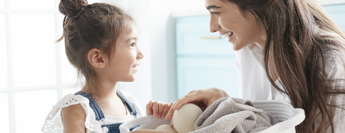 mother and daughter doing laundry